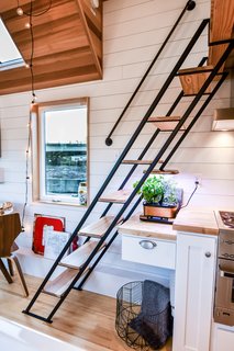 Tru Form Tiny optimized the kitchen by extending the counter to the space underneath the stairs.