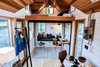 Modern home with Living Room, Sofa, Coffee Tables, Wall Lighting, Gas Burning Fireplace, Light Hardwood Floor, and Bench. Elevator bed in up position leaves an open living area and office. Photo of Not So tiny Tiny, for a Doctor in California