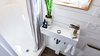 Modern home with Wall Lighting. Small Comfortable Bathroom. Tru Form Tiny Photo 15 of Full Solar Tiny Home & Open Layout