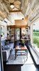 Modern home with Living Room, Ceiling Lighting, Coffee Tables, Dark Hardwood Floor, Sofa, and Wall Lighting. Living Room with large living room Photo 7 of Full Solar Tiny Home & Open Layout