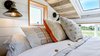 Modern home with Bedroom, Wall Lighting, and Bed. Loft with several windows. Tru Form Tiny Photo 11 of Full Solar Tiny Home & Open Layout