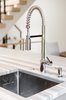 Modern home with Kitchen, Marble Counter, Undermount Sink, Cooktops, Refrigerator, Ceiling Lighting, Range, Microwave, Range Hood, Light Hardwood Floor, Dishwasher, Colorful Cabinet, and Wine Cooler. Kitchen detail Photo 20 of The Doyle Residence
