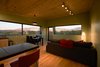 Modern home with Living Room. Expansive windows capturing the views of the Sange De Christo mountain Range, the Arroyo Hondo Valley and the Rio Grande. Photo 3 of SkyNest