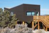 Modern home with Exterior, Wood Siding Material, Green Roof Material, House Building Type, and Butterfly RoofLine. Open joint wood siding cladding the super- insulated walls. Photo 11 of SkyNest