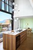 Modern home with Kitchen, Engineered Quartz Counter, Wine Cooler, Undermount Sink, Dishwasher, Wood Cabinet, Medium Hardwood Floor, and Pendant Lighting. Slide up garage door Photo 6 of Beatty Street Loft