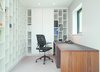Modern home with Office, Study Room Type, Desk, and Shelves. Office Shelving
• Organisation to the extreme, this office space includes a series of staggered pigeon holes that run the length of the wall and are painted white to reflect light around the room
• Adjacent to the display shelving is a coordinating cupboard unit with fixed shelf and five adjustable shelves
Desk
• A generous writing desk with leather desktop fitted with cable flaps, grommets and integral pen tray
• Walnut end panels and three-drawer central pedestal for stability and balance of design
Photo 5 of 'Linear Living' with the latest project by William Garvey