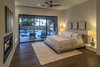 Modern home with Bedroom, Medium Hardwood Floor, Accent Lighting, Table Lighting, Night Stands, Bed, Ceiling Lighting, and Chair. Master Bedroom Suite features pool access, 2-way fireplace, Spa Bath and His & Hers walk-in Closets Photo 4 of The Allen House