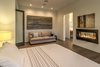 Modern home with Bedroom, Accent Lighting, Chair, Bed, Storage, Ceiling Lighting, Wardrobe, Night Stands, Medium Hardwood Floor, and Table Lighting. Master Suite sitting area Photo 6 of The Allen House