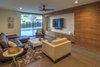 Modern home with Living Room, Chair, Sofa, End Tables, Medium Hardwood Floor, Coffee Tables, Ceiling Lighting, and Sectional. TV Area Features Walnut Cabinetry and Hickory Wood Floors Photo 8 of The Allen House
