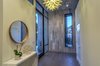 Modern home with Hallway and Medium Hardwood Floor. Front Foyer Features Oversized Glass Door Brings The Lime Stone Inside Photo 11 of The Allen House