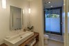 Modern home with Bath Room, Ceiling Lighting, Wood Counter, Vessel Sink, Open Shower, Enclosed Shower, Medium Hardwood Floor, Full Shower, Accent Lighting, One Piece Toilet, and Wall Lighting. Pool Bath With Oversized Glass Door For Indoor/Outdoor Shower Photo 12 of The Allen House
