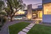 Modern home with Outdoor, Large Patio, Porch, Deck, Grass, Trees, Large Pools, Tubs, Shower, Swimming Pools, Tubs, Shower, Back Yard, Stone Patio, Porch, Deck, Metal Fences, Wall, Shrubs, Concrete Patio, Porch, Deck, and Landscape Lighting. Grassy Area For Dogs or Kids Play Area Photo 13 of The Allen House