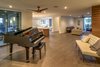 Modern home with Living Room, End Tables, Ceiling Lighting, Medium Hardwood Floor, Bench, and Sofa. Open Floor Plan Provides Lots of Options With Spaces Adjacent to Kitchen Photo 14 of The Allen House