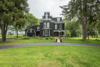 Modern home with Exterior and Brick Siding Material. This home is triple brick with board and batten siding on carriage house addition. Photo of The Empress