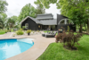 Modern home with Outdoor. A large outdoor space to view the back of the home with multiple roof lines and the large semi circular window to the loft which is a unique architectural element adding great natural light to this space. Photo 2 of The Empress