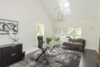 Modern home with Office. The office space is large on the main floor with vaulted ceilings and views to the side yard and a glass walk out to the pool area. Photo 9 of The Empress