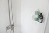 Modern home with Bath Room, Enclosed Shower, Vessel Sink, Ceramic Tile Floor, Drop In Sink, Ceiling Lighting, Tile Counter, Corner Shower, Ceramic Tile Wall, Wall Lighting, Porcelain Tile Floor, and Two Piece Toilet. Organic soap and shampoo Photo 12 of The Litwood House