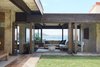Modern home with Living Room and Sectional. Snyder originally built the home for himself on a site that was in town, but still very rural at the time. Using the natural topography, he rotated the house to enjoy coastline views of the Oahu shoreline, from Maunalua Bay all the way to Koko Head. Photo of Live inspired in this Japanese Musician's midcentury indoor/outdoor home asking $2.95 million