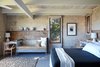 Modern home with Bedroom, Carpet Floor, Chair, Ceiling Lighting, Shelves, Bench, Night Stands, Bed, and Rug Floor. Each bedroom has large windows with mesmerizing views of the Pacific Ocean. Photo 3 of Live inspired in this Japanese Musician's midcentury indoor/outdoor home asking $2.95 million
