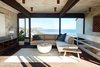 Modern home with Living Room, Sectional, and Ceiling Lighting. Architecturally striking with large picture windows, you can see the calming blues of the Pacific Ocean from every room of the house. Photo 6 of Live inspired in this Japanese Musician's midcentury indoor/outdoor home asking $2.95 million