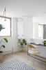 Modern home with Office, Desk, Study Room Type, Chair, Medium Hardwood Floor, and Rug Floor. The flexible home-office space overlooks the living room below Photo of Hackney Mews House