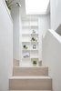 Modern home with Staircase and Wood Tread. A new stair to the kitchen is clad in oak, and natural light floods in from the roof light above Photo 5 of Hackney Mews House