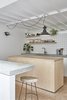 Modern home with Kitchen, Wood Counter, Wood Cabinet, Drop In Sink, White Cabinet, Wall Lighting, Pendant Lighting, Ceramic Tile Floor, Ceramic Tile Backsplashe, and Concrete Counter. Bespoke joinery, tiled finishes, concrete tops and high-level mirrors to the kitchen Photo 6 of Hackney Mews House