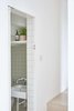Modern home with Bath Room, Wall Mount Sink, Ceramic Tile Wall, One Piece Toilet, and Wall Lighting. The downstairs WC is concealed behind a hidden door Photo 10 of Hackney Mews House