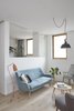 Modern home with Living Room, Pendant Lighting, Sofa, Chair, Floor Lighting, Medium Hardwood Floor, and Coffee Tables. The living room and home-office open up into one continuous space, or can be separated with bespoke folding doors Photo 9 of Hackney Mews House