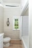 Modern home with Bath Room, Engineered Quartz Counter, Light Hardwood Floor, and Alcove Tub. The bathroom includes a tub with tile surround. Photo 6 of Saltbox Tiny Home