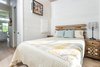 Modern home with Bedroom, Floor Lighting, Light Hardwood Floor, and Bed. The bedroom features a 9 foot ceiling. Photo of Saltbox Tiny Home