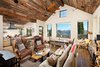 Modern home with Living Room, Wood Burning Fireplace, Medium Hardwood Floor, Coffee Tables, Track Lighting, Sofa, Chair, and Ceiling Lighting. Living Room Photo 2 of Smith Cabin Aspen