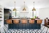 Modern home with Kitchen, Subway Tile Backsplashe, Range Hood, Range, Wood Counter, Refrigerator, Colorful Cabinet, Undermount Sink, Ceramic Tile Floor, and Pendant Lighting. Cabinets painted Farrow & Ball Studio Green, pendants by Nickey Kehoe, bar stools by Thomas Hayes Gallery, floors by Cle Tile Photo 7 of Mansfield