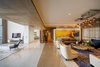 Modern home with Living Room, Bookcase, Sofa, Marble Floor, Pendant Lighting, Storage, Shelves, and Coffee Tables. Plush Formal Living Photo 3 of Aurum Penthouse