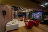 Modern home with Living Room, Coffee Tables, Console Tables, Accent Lighting, Sofa, Ceiling Lighting, Bookcase, and Storage. Transformable Home Theatre Photo 18 of Aurum Penthouse