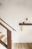 The entry introduces the home's mixed wood elements of white oak and walnut. The staircase railing and hook rack were made by Kaimade Woodworking with locally sourced walnut. Photo 11 of Balboa Residence modern home