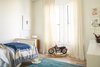 Modern home with Storage and Light Hardwood Floor. One of the boy's rooms has a simple white palette and a sea-inspired rug. Photo 15 of Balboa Residence