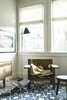 Modern home with Living Room, End Tables, Accent Lighting, Chair, and Light Hardwood Floor. The belted leather Spanish Chair by Børge Mogensen creates a reading spot in the family room. The stool and media credenza are by local woodworkers Mellon Winslow Design Build. Photo 14 of Balboa Residence