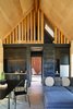 Modern home with Kitchen, Concrete Floor, Wood Cabinet, Wood Counter, Refrigerator, Cooktops, Wall Lighting, Undermount Sink, and Concrete Backsplashe. common area Photo 4 of Folly | Off Grid