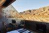 Modern home with Dark Hardwood Floor, Night Stands, Bedroom, and Bed. stargazing suite Photo 8 of Folly | Off Grid