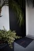 Modern home with Exterior and House Building Type. The entrance features a custom steel black door, integrated with a smart home system that can be unlocked with a smartphone. Photo 2 of Normal Heights Residence
