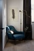 Modern home with Bedroom, Light Hardwood Floor, Lamps, Night Stands, Bed, Floor Lighting, Ceiling Lighting, and Chair. Blue velvet armchair with black stained oak side table in the guest room. Feather print on handmade Nepalese paper by an artist in Brooklyn, New York. Photo 4 of Normal Heights Residence