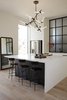 Modern home with Kitchen, Light Hardwood Floor, Microwave, Refrigerator, White Cabinet, Dishwasher, Range Hood, Metal Backsplashe, Engineered Quartz Counter, Undermount Sink, and Pendant Lighting. The waterfall countertop is paired with black stained oak counter stools from Afteroom. Photo 13 of Normal Heights Residence