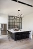 Modern home with Kitchen, Engineered Quartz Counter, Refrigerator, Light Hardwood Floor, Undermount Sink, Pendant Lighting, and White Cabinet. The minimal and functional kitchen features a built-in island that seats 5-6, but more often it serves as a prep-working surface for catered parties. Photo 14 of Normal Heights Residence