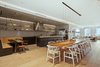 Modern home with Kitchen, Wood Counter, Refrigerator, Dishwasher, Range Hood, Cooktops, Open Cabinet, Beverage Center, Microwave, Drop In Sink, Ice Maker, Ceiling Lighting, Light Hardwood Floor, and Stone Tile Backsplashe. Kitchen Photo of Joon & Arum Tribeca Apartment