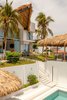 Modern home with Exterior, A-Frame RoofLine, Beach House Building Type, Green Roof Material, Flat RoofLine, Stucco Siding Material, Glass Siding Material, Concrete Siding Material, and Metal Roof Material. Tropical Modern Living Photo 10 of Casa Ilios (Seven Bedrooms)