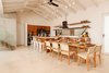 Modern home with Dining Room, Porcelain Tile Floor, Ceiling Lighting, Chair, Track Lighting, Table, Bar, and Stools. Kitchen and Dining Photo 17 of Casa Ilios (Seven Bedrooms)