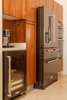 Modern home with Kitchen, Track Lighting, Wine Cooler, Dishwasher, Wall Oven, Refrigerator, Porcelain Tile Floor, Mirror Backsplashe, Wood Cabinet, Ceiling Lighting, Range Hood, Ice Maker, Microwave, Mosaic Tile Backsplashe, Cooktops, Undermount Sink, and Beverage Center. Costa Rican Teak cabinets and the essentials in life -- espresso and champagne Photo 13 of Casa Ilios (Seven Bedrooms)