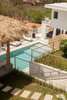 Modern home with Outdoor, Swimming Pools, Tubs, Shower, Trees, Shrubs, Grass, Hardscapes, Front Yard, and Walkways. So many different areas to enjoy !! Photo 15 of Casa Ilios (Seven Bedrooms)