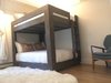 Modern home with Bedroom, Light Hardwood Floor, Bunks, Dresser, Storage, Ceiling Lighting, Track Lighting, and Chair. Full sized bunk beds Photo 4 of Modern Riverfront Townhouse in Aspen